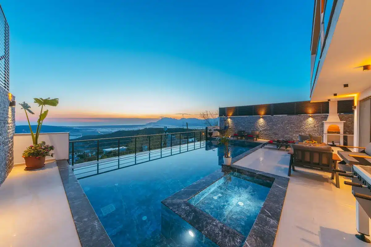 Heated indoor-outdoor pool with mountain panorama backdrop and alpine scenery