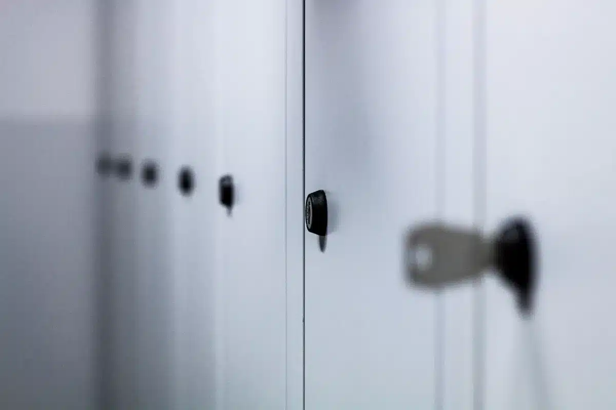 Mudroom with individual metal-mesh lockers for organizing children's sports gear and backpacks