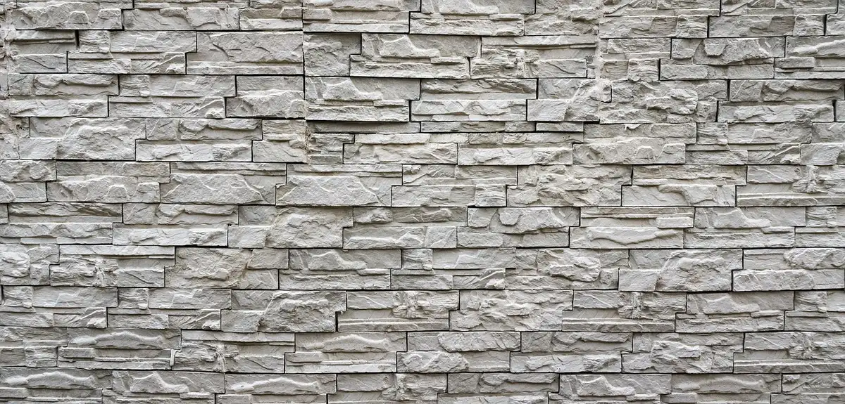 Close-up of textured three-dimensional wall tiles with light and shadow
